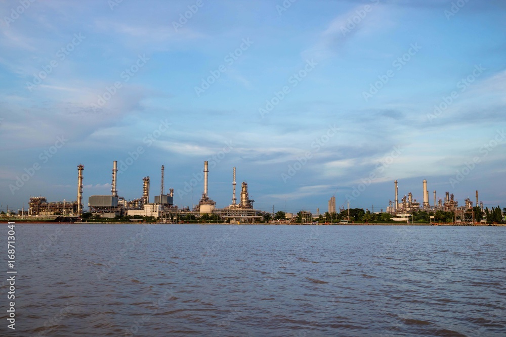 Oil refinery plant near river at twilight, Business and  Industry concept