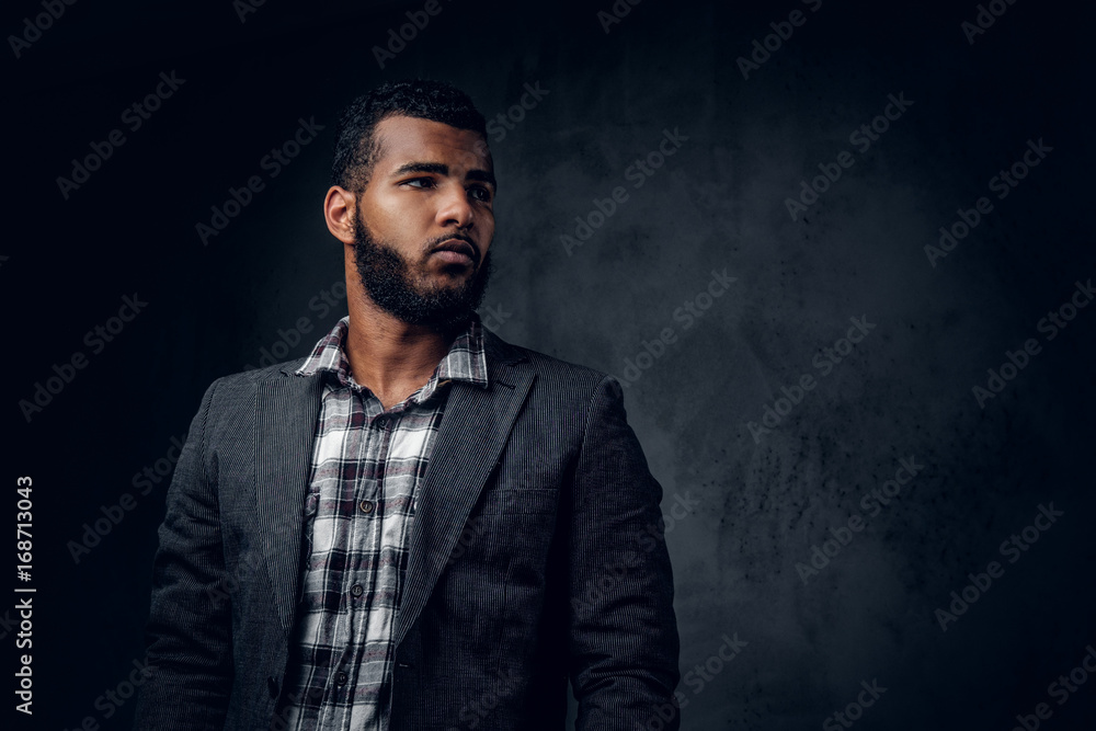 Black hipster male dressed in a fleece shirt and a jacket. Black hipster male dressed in a fleece shirt and a jacket.