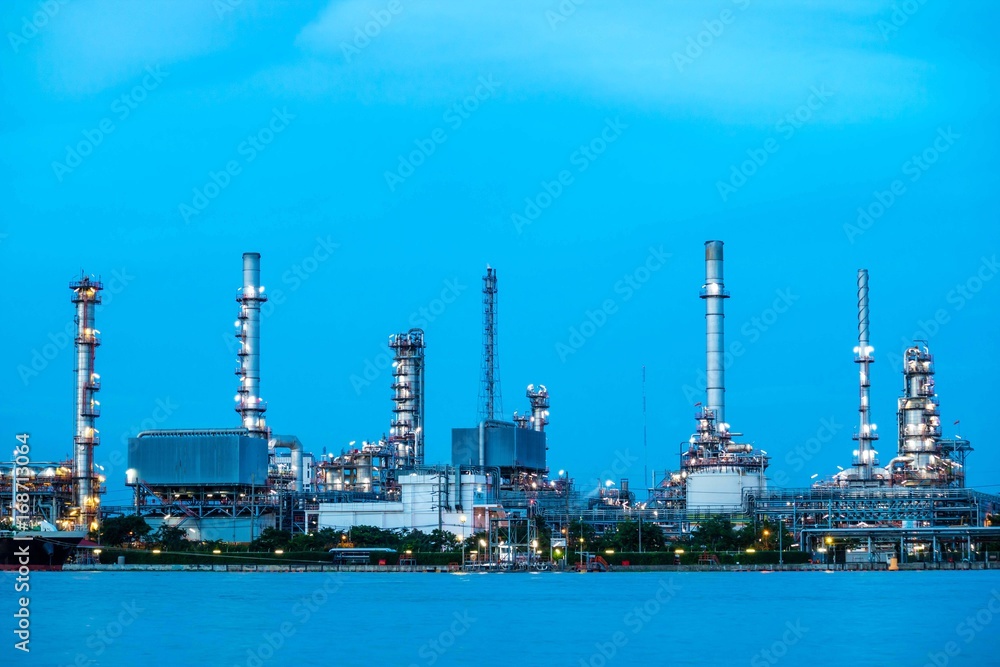 Oil refinery plant near river at twilight, Business and  Industry concept