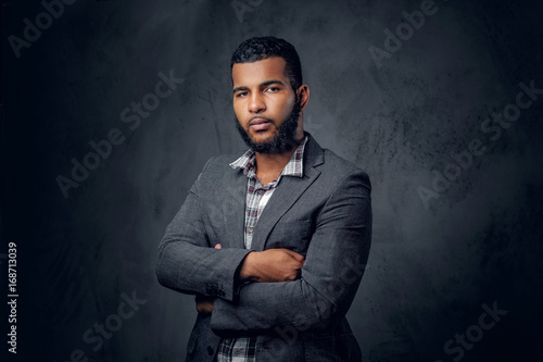 Black hipster male dressed in a fleece shirt and a jacket.
