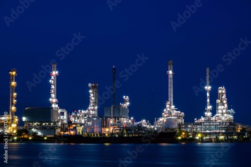Oil refinery plant near river at twilight, Business and  Industry concept © Pawin