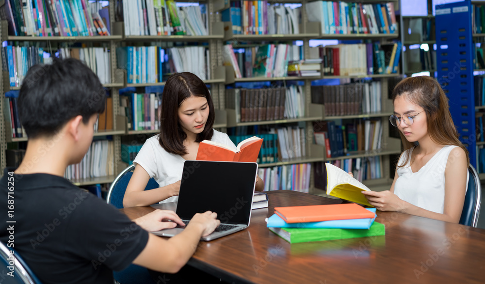 Young students asian together group teenager smile with laptop computer, school folders reading book at high school university campus college library knowledge center for learning bright idea. Young students asian together group teenager smile with laptop computer, school folders reading book at high school university campus college library knowledge center for learning bright idea.