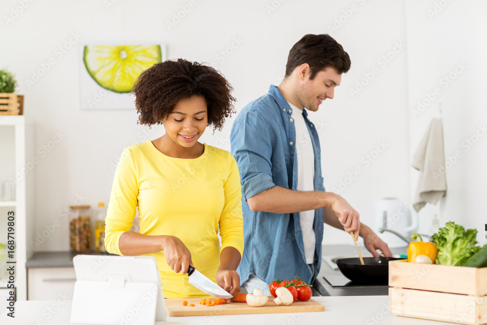 happy couple cooking food at home kitchen happy couple cooking food at home kitchen