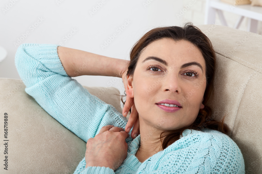 Friendly smiling middle-aged woman at home. The beautiful face close up. Friendly smiling middle-aged woman at home. The beautiful face close up.