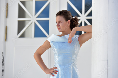 Beautiful brunette in pale blue evening dress outdoor. photo