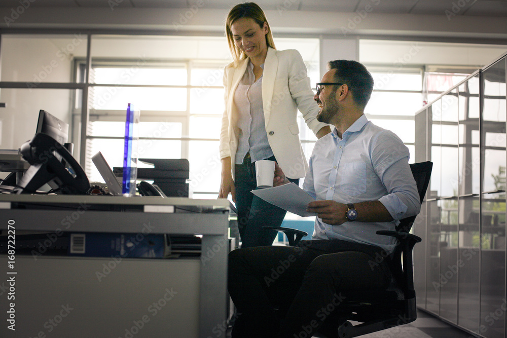 Two business people having funny conversation. Business man holding document. Two business people having funny conversation. Business man holding document.