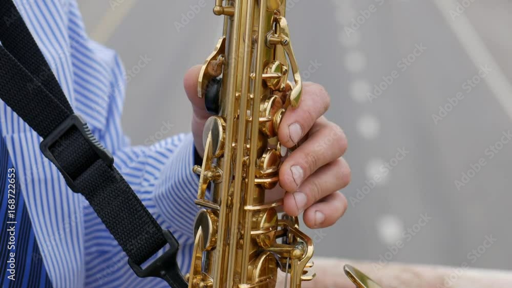 A saxophonist plays the saxophone A saxophonist plays the saxophone