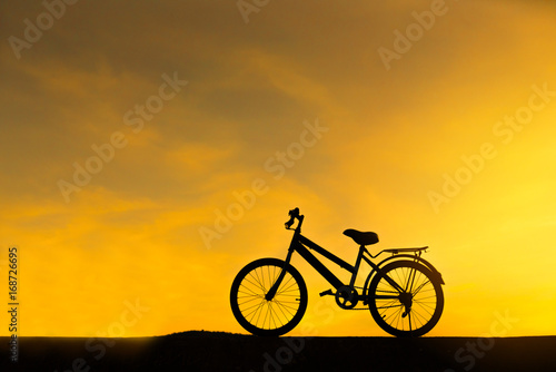 silhouette of bicycle with sunset background