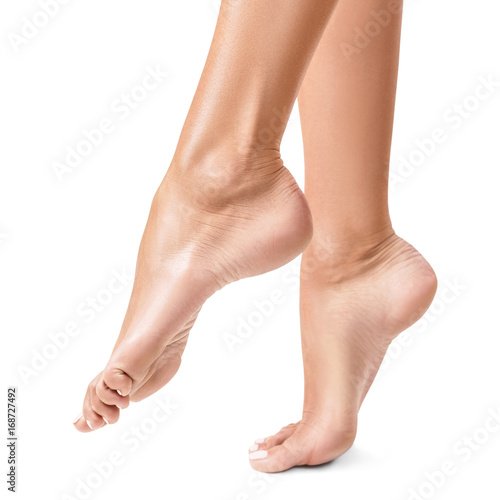 Beautiful womans feet isolated on white. © Dmitrii Kotin