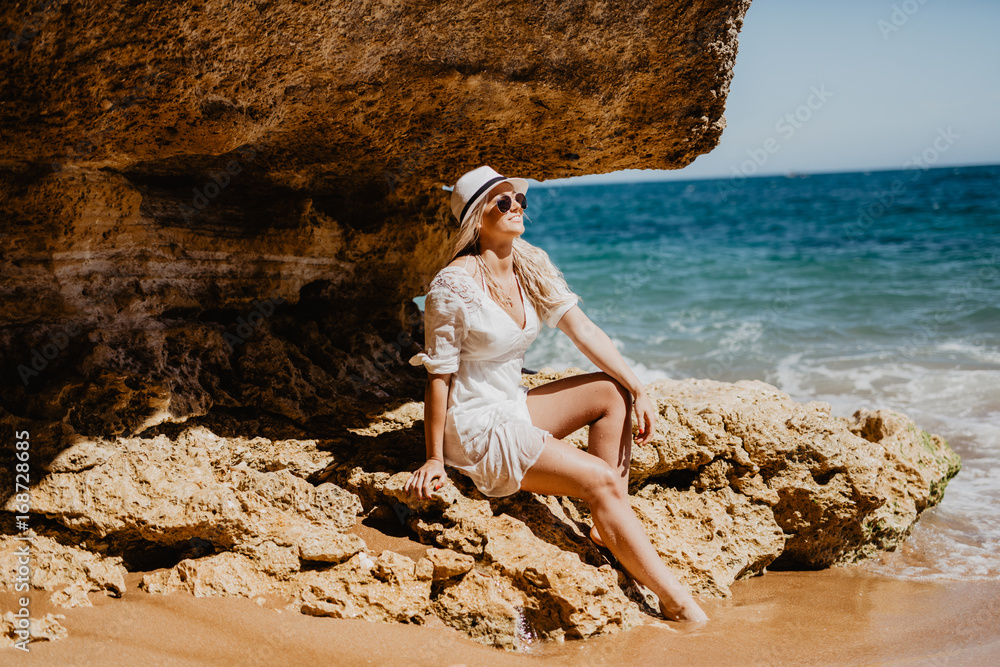Fototapeta premium Side view of beautiful beauty woman on the cave beach of ocean coast.