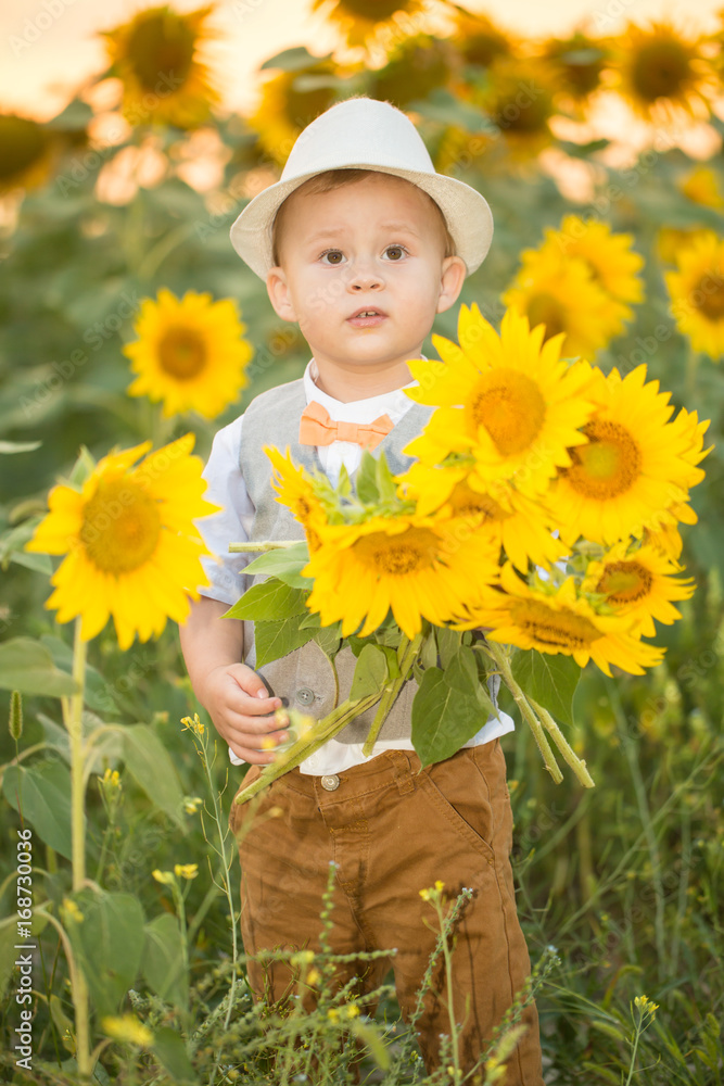 Beautiful child with sunflower in spring field Beautiful child with sunflower in spring field