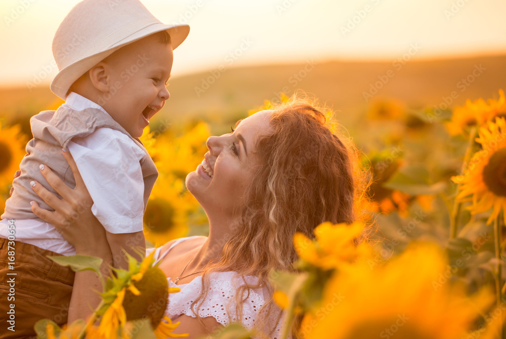 Mother with baby son in sunflower field Mother with baby son in sunflower field