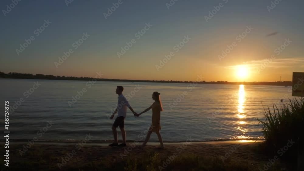 Silhouette of a couple in love on a sunset tropical background. Silhouette of a couple in love on a sunset tropical background.