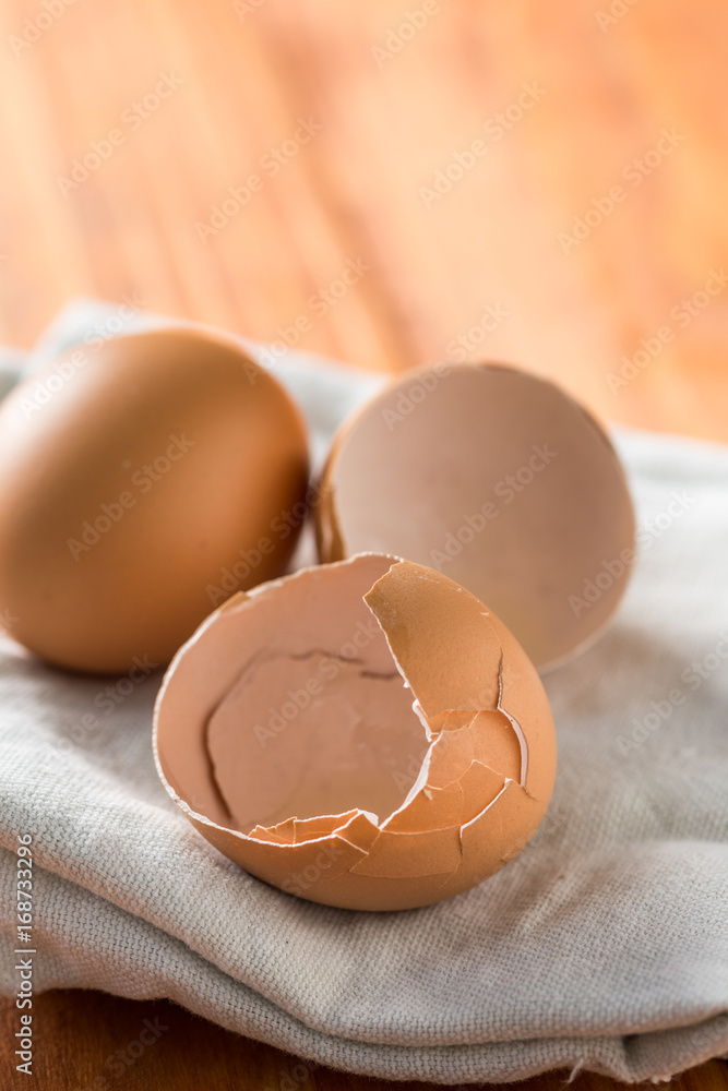 Closeup macro egg and eggshells on the kitchen dishtowel Closeup macro egg and eggshells on the kitchen dishtowel