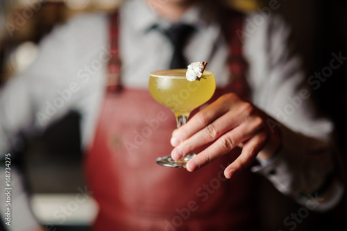 bartender hands with cocktail on the bar stand
