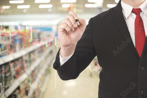 Business man pointing in market store.