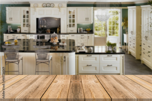Empty light wood table top with kitchen background. Leave space for placement you background - can be used for display or montage or mock up your products.