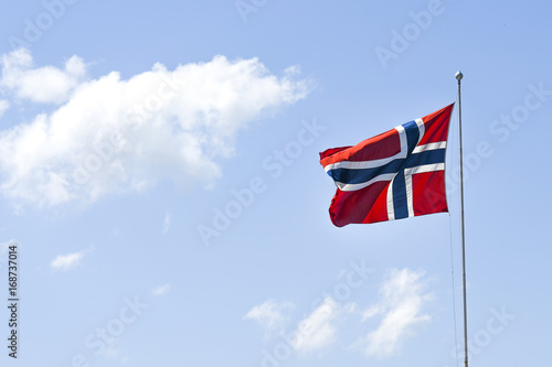 Flag of Norway, waving in the wind on a blue sky on a sunny day.