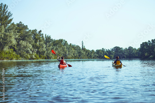 A canoe trip along the river along the forest in summer. © trek6500