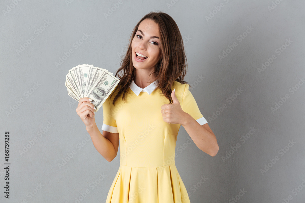 Beautiful young caucasian lady holding money in hands Beautiful young caucasian lady holding money in hands