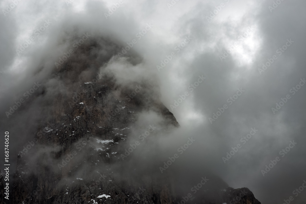 Cloudy snowy mountains peaks landscape. Dolomites Alps