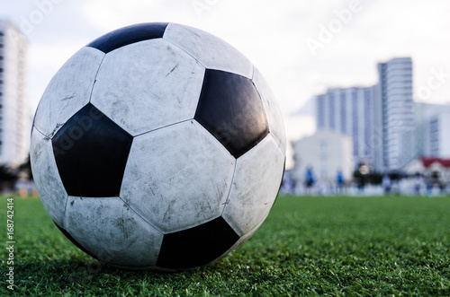 Soccer Football on the green grass of Soccer field.