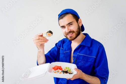 Handsome guy delivering sushi