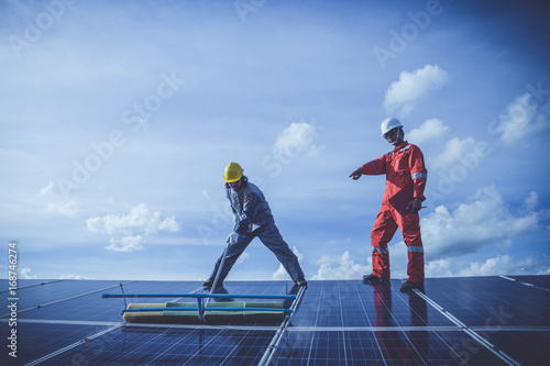 labor working on cleaning solar panel with water clean at solar power plant 