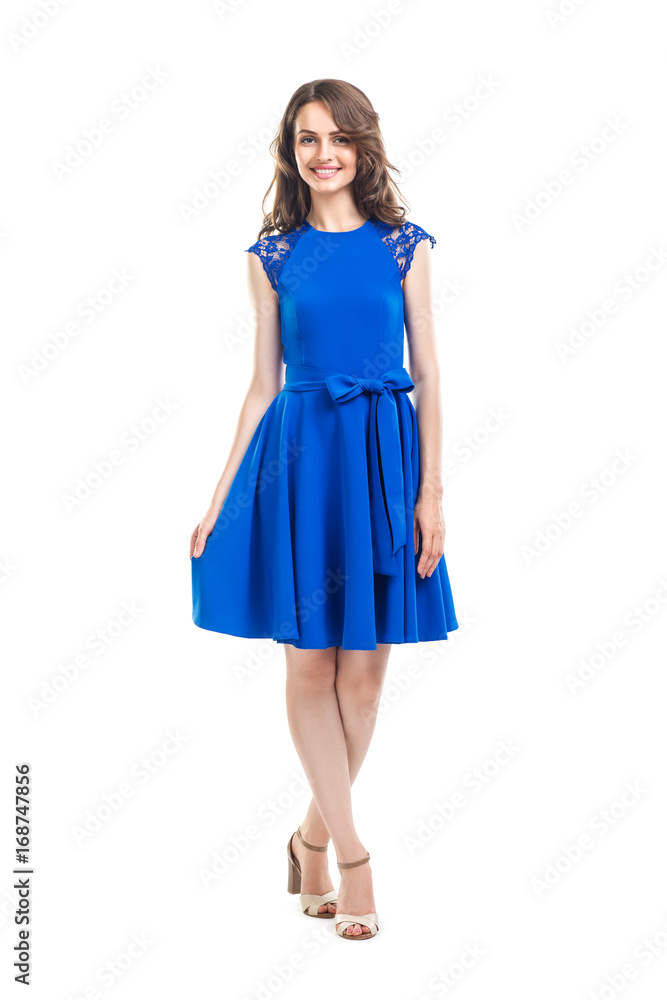 Happy beautiful woman in blue dress posing in studio isolated on white background