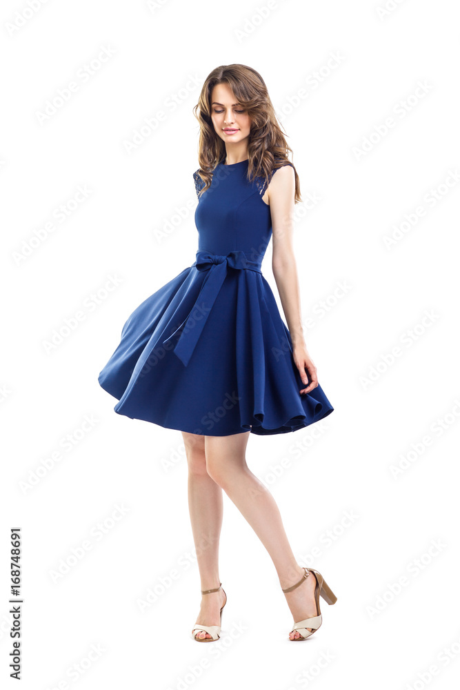Happy beautiful woman in blue dress posing in studio Happy beautiful woman in blue dress posing in studio