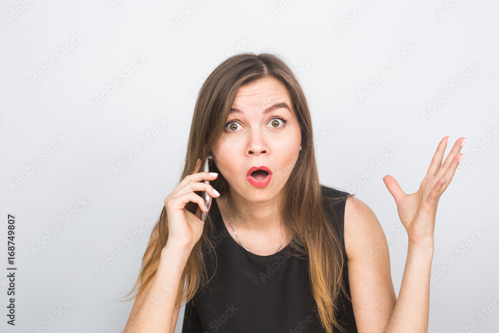 Surprised young businesswoman talking on the mobile phone Surprised young businesswoman talking on the mobile phone