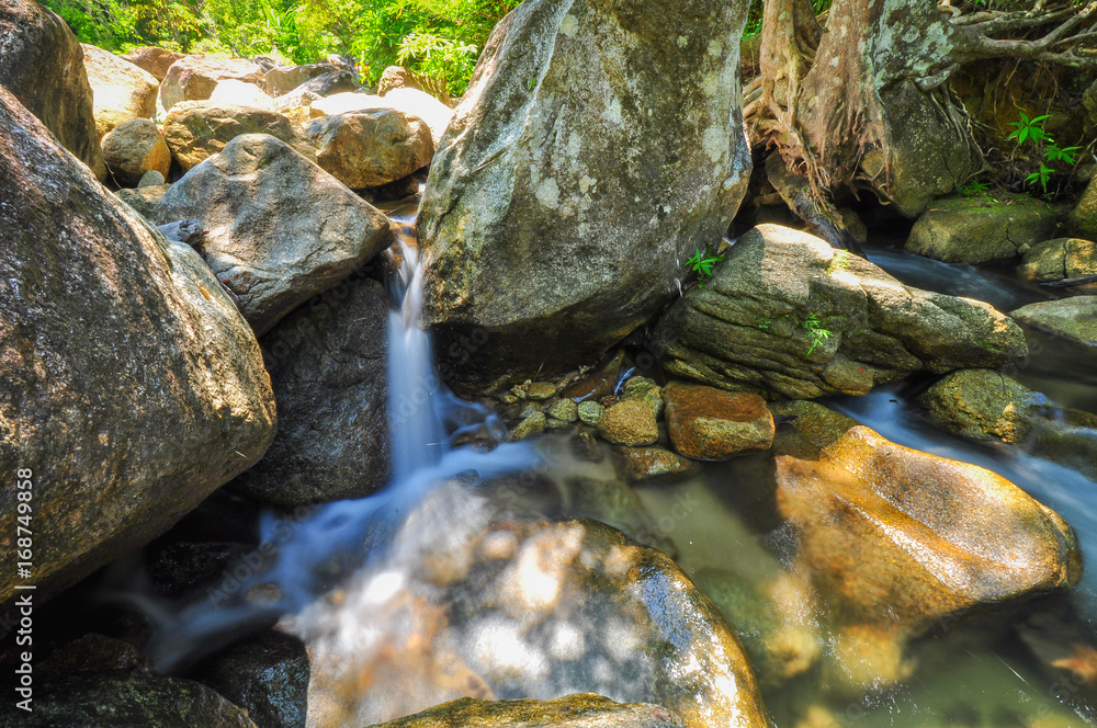 The soft stream is flowing through the rocks. The soft stream is flowing through the rocks.