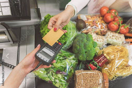 Fotografie Woman going to make payment in supermarket