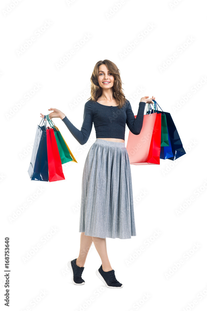 Happy beautiful woman with many shopping bags isolated on white background