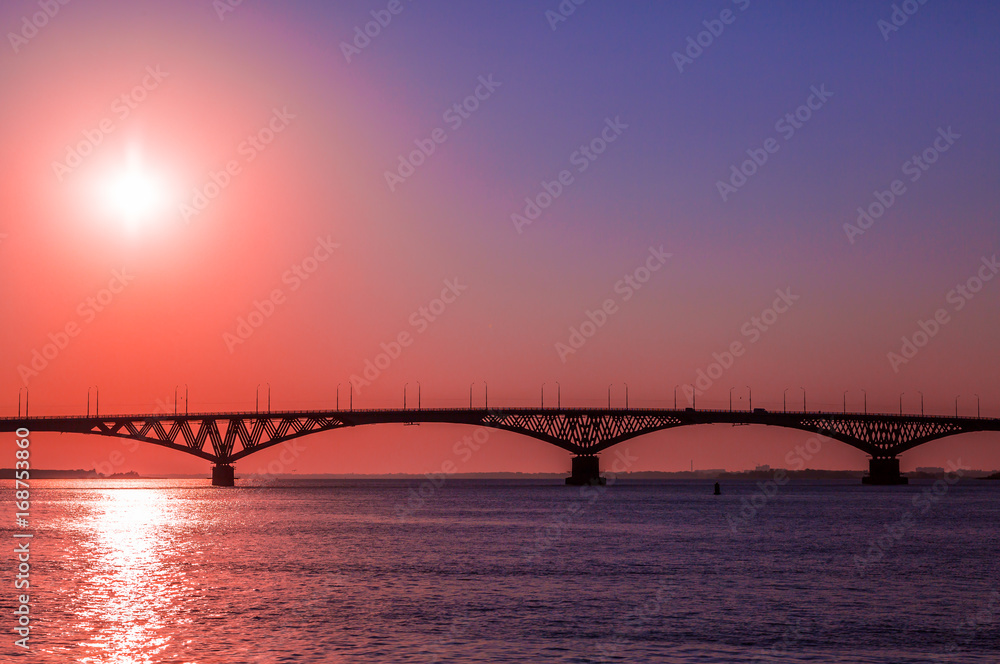Sunrise over a road bridge across the Volga river between the cities of Saratov and Engels, Russia.