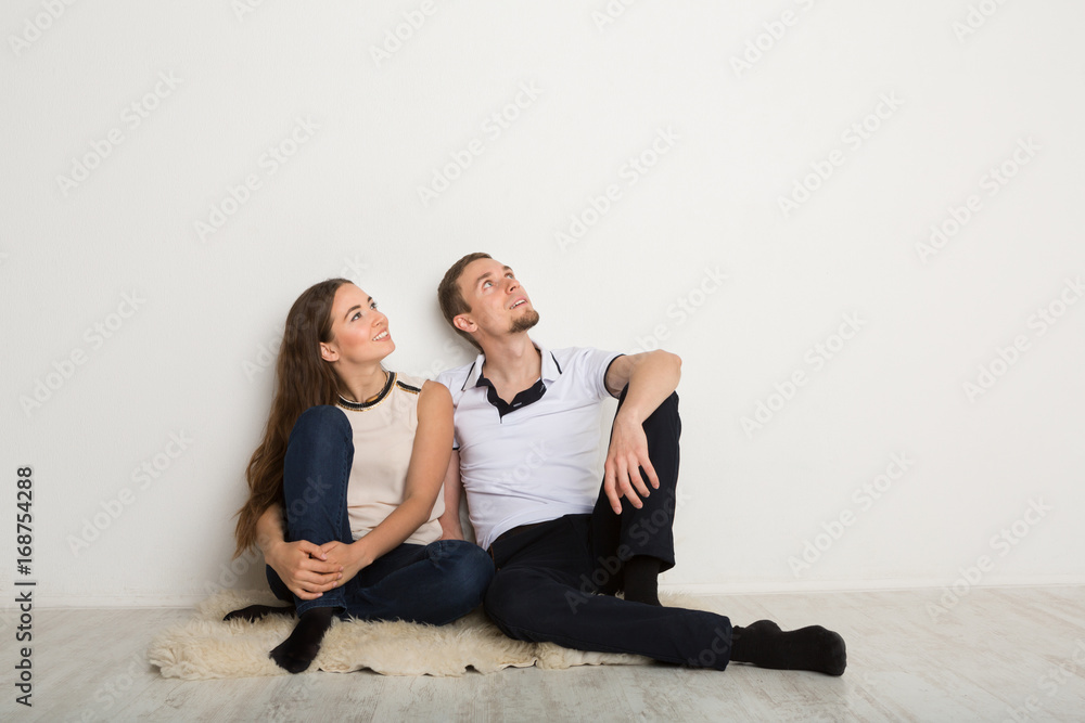 Couple looking up at white background Couple looking up at white background