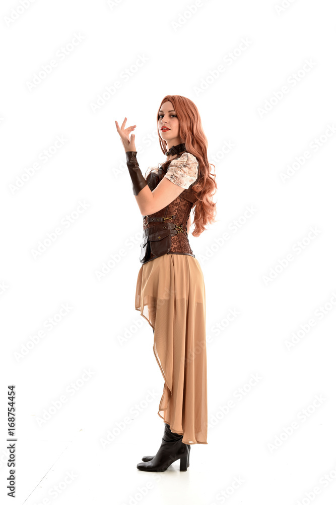 full length portrait of a red haired lady wearing steampunk inspired outfit, standing pose against a white background. full length portrait of a red haired lady wearing steampunk inspired outfit, standing pose against a white background.