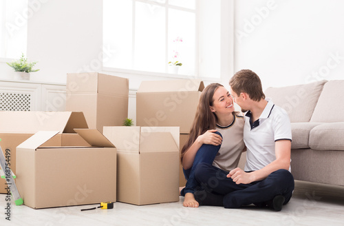 Young couple unpacking moving boxes