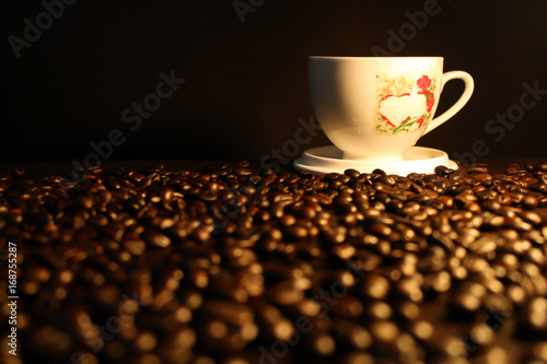 cup of hot coffee on coffee beans background