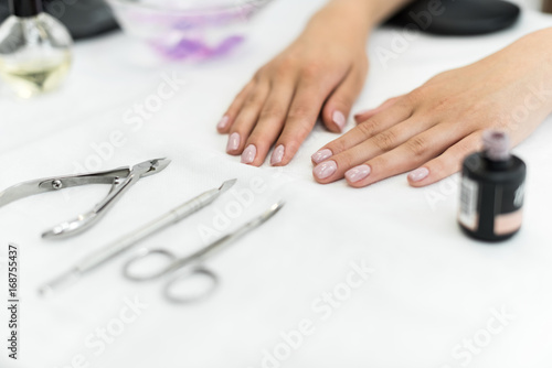 polished nails with manicure tools