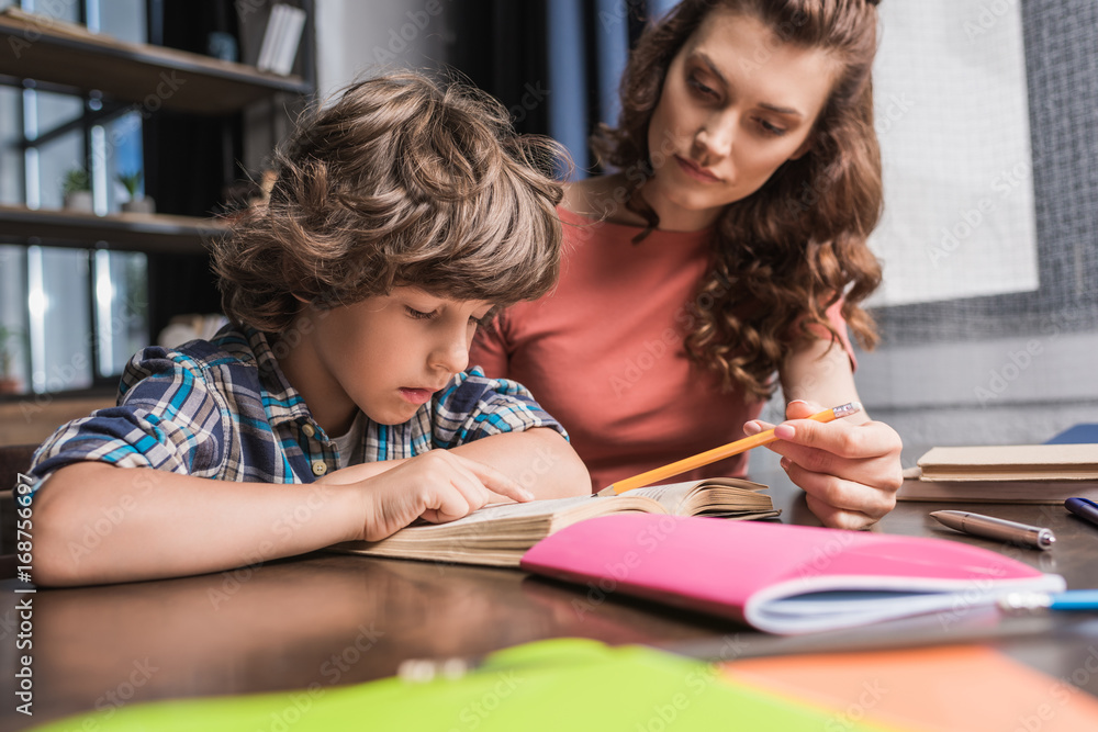 mother helping son with homework mother helping son with homework
