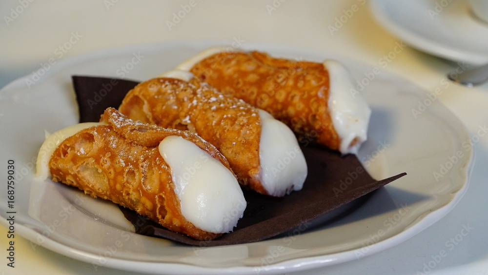 Italian desserts, Cannoli on a plate Italian desserts, Cannoli on a plate