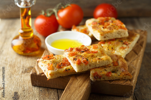Homemade bread with tomatoes, herbs and olive oil