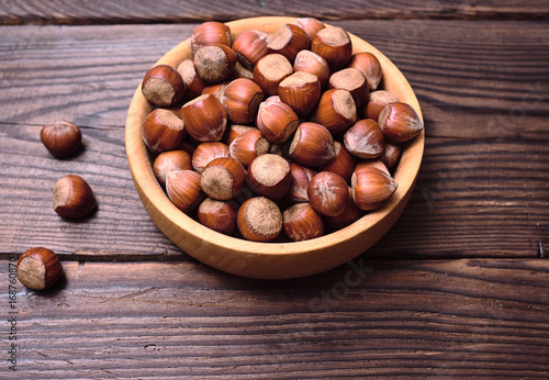 Hazelnuts in a shell in a wooden bowl