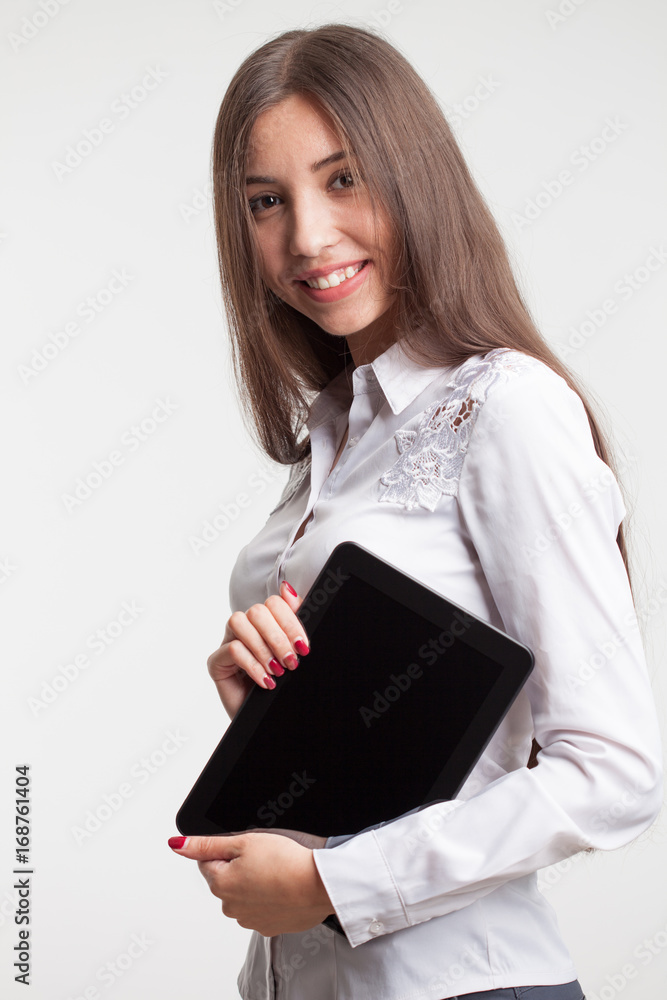 Smiling young businesswoman showing blank no-name tablet pc monitor with copyspace area for slogan or text message. business concept. Smiling young businesswoman showing blank no-name tablet pc monitor with copyspace area for slogan or text message. business concept.