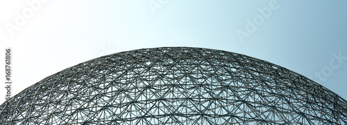 Dome shape structure with a blue and gray sky photo