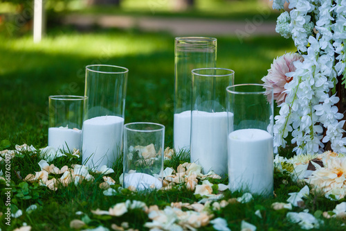 Wedding decorations. country style. Solemn ceremony. Wedding in nature. Candles in decorated jars. Just married. Wedding decor.