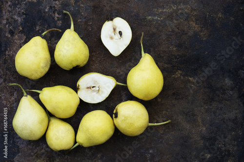 Ripe yellow pears on an old metalic background. Top view. Vintage tones