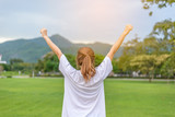 Woman exercise outdoors in park in sunrise morning with mountain in background