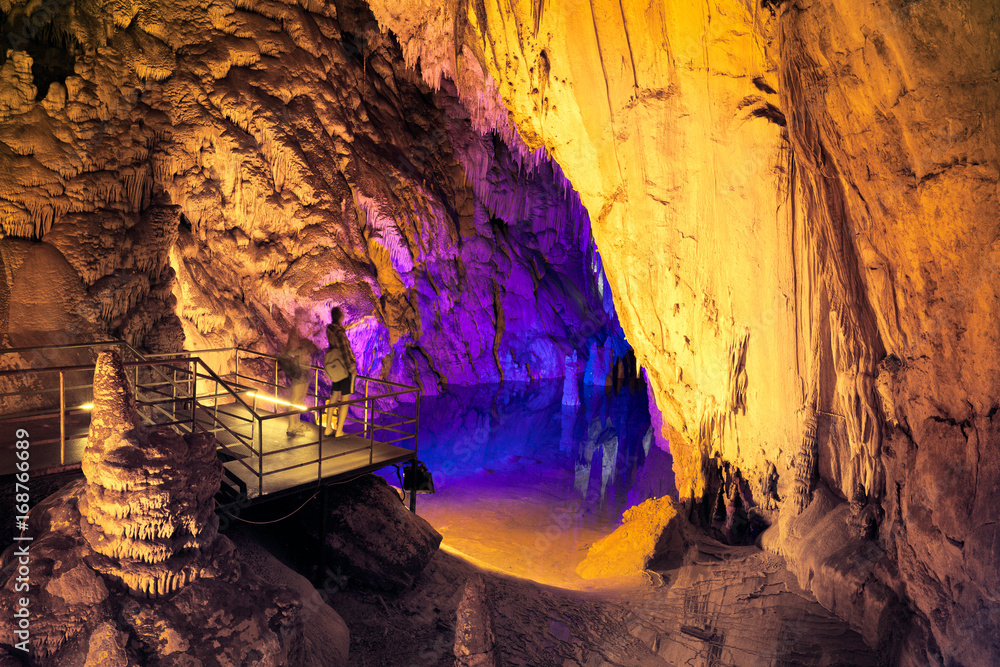 People admire the beauty of underground lake in Dim cave. Valley of Dim river, Alanya, Turkey